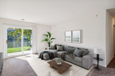 A living room with a grey couch and a coffee table.